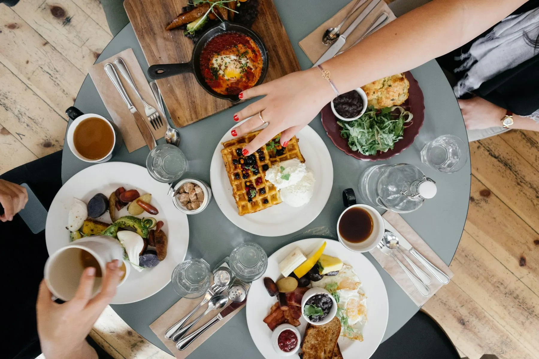 Friends sharing dishes around a restaurant table