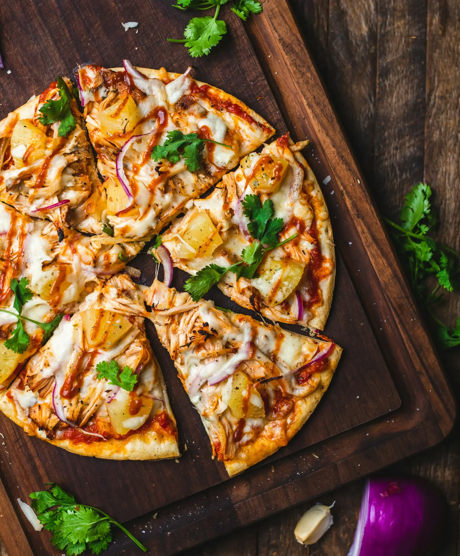 A sliced pizza on a wooden board